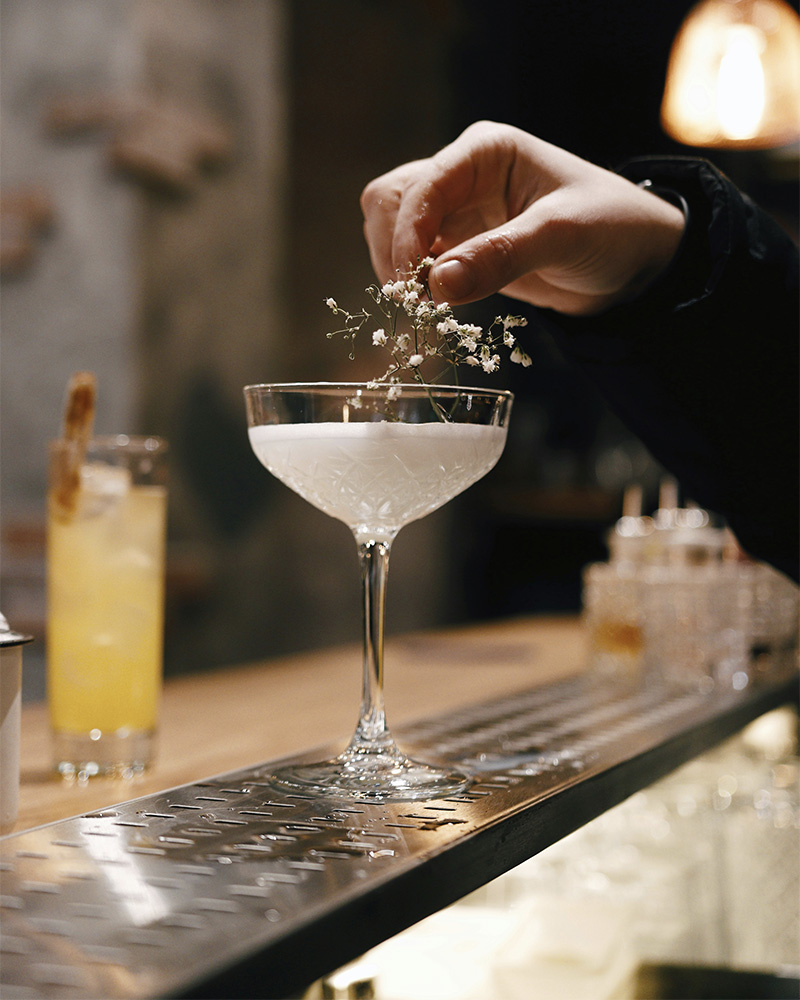 a cocktail being crafted on a countertop