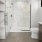 a toilet and a glass shower