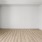 a large empty room with faux-wood floors