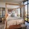 natural lighting pours through floor-to-ceiling windows in bedroom