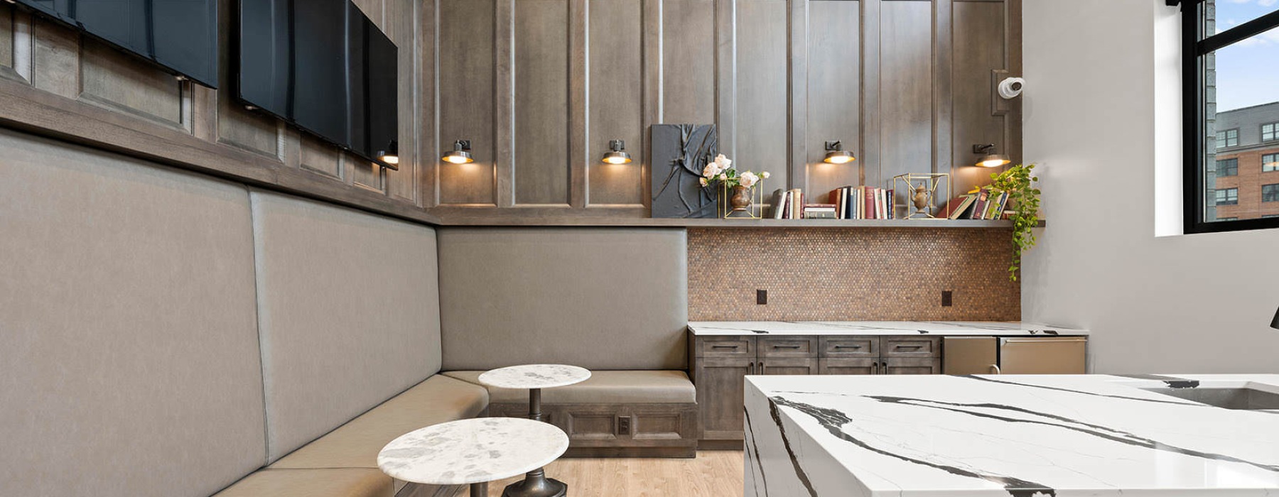 clubroom with tables, chairs and wall mounted tvs
