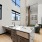 large windows brighten clubroom with sink and bookshelves