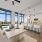 open concept dining area next to kitchen and large windows