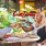 couple toasts drinks at restaurant table with food
