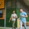 men walking outside of local restaurant with glasses of beer in hand