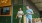 men walking outside of local restaurant with glasses of beer in hand