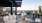 partially covered rooftop balcony with tables and chairs