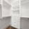 walk-in closet with built-in shelving and drawers